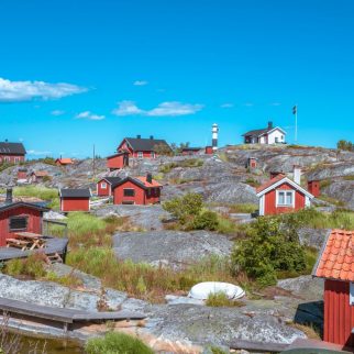 Röda små hus under en blå himmel
